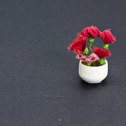Model round white vase with red fabric flowers