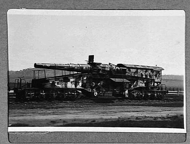 Large railway gun outdoors.