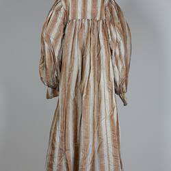 Front view, long dress, cream and tan stripes.