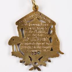 Gold ornament with inscription, back view.