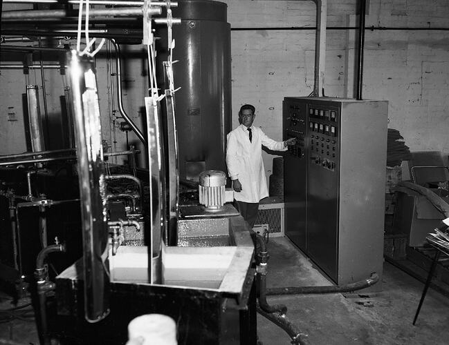 Monochrome photograph of a factory worker.