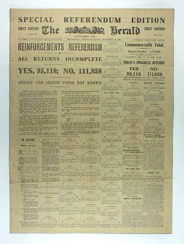 Newspaper page with black printed text on yellow paper.