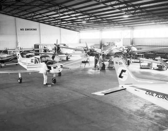 Monochrome image of an aircraft hangar.