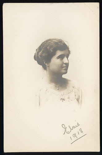 Monochrome postcard of a woman.