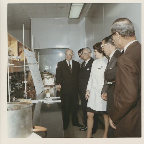 Group of men with female researcher in laboratory.