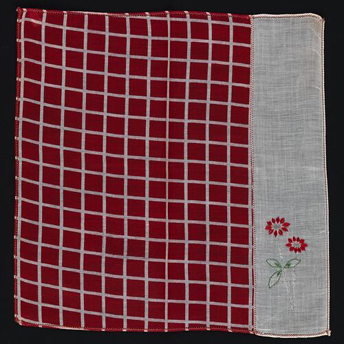Red and White unfolded handkerchief with embroidered flowers.