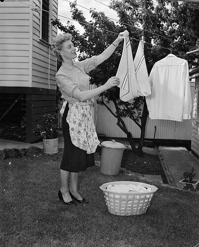 Woman Using a Plastic Clothes Basket, Melbourne, Victoria, Nov 1958