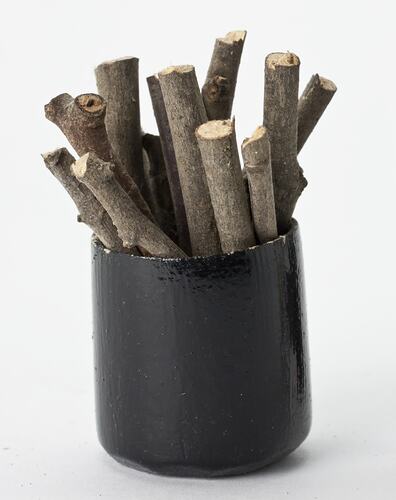 Miniature bucket of firewood from a doll's house.