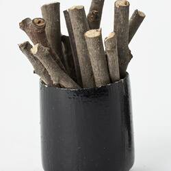 Miniature bucket of firewood from a doll's house.