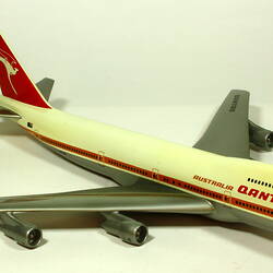 White model plane with red trim and tail. Grey wings. Right front three quarter view.