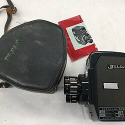 Rectangular black movie camera with customised leather case. Instruction booklet.