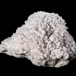 Pale pink mineral specimen.