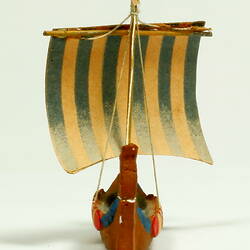 Rear view of ship with dragon head and shields.