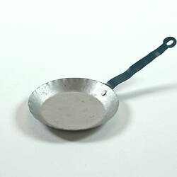 Toy silver frying pan.