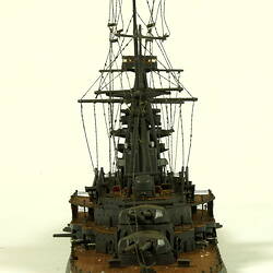 Naval ship with mast, rear view.
