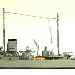 Naval ship with two masts, facing left.