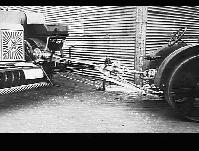 10 FT SUNSHINE HEADER FITTED WITH POWER TAKE OFF AND TRACTOR HITCH CONNECTED TO MASSEY HARRIS (WALLIS) TRACTOR.