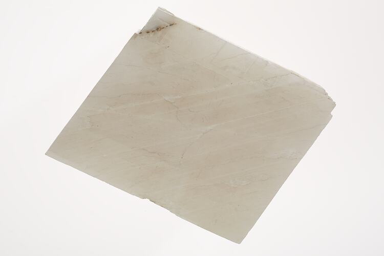 White, flat, sheet-like mineral.