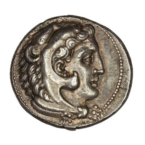 Head of Herakles wearing lion's skin facing right.