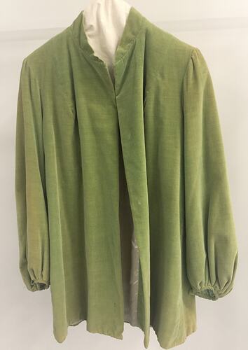 Front view of green jacket on hanger.