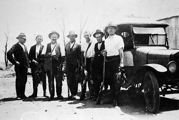 [Hunters holding a brace of ducks, 1920s.]