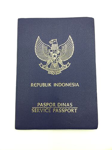 Dark blue passport cover with gold printing.