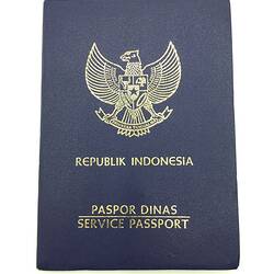 Dark blue passport cover with gold printing.