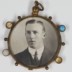 Pendant with photo showing man's upper body.