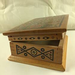 Timber inlay jewellery box. Geometric patterns in dark and light light brown, blue, yellow, white and red.