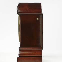 Mantel clock, mahogany case. Left profile.