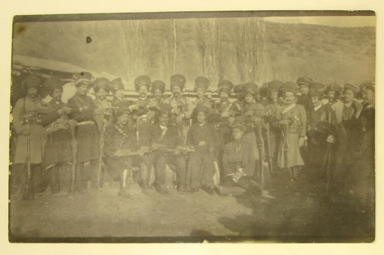 Posed group of men in Kurdish military uniform.