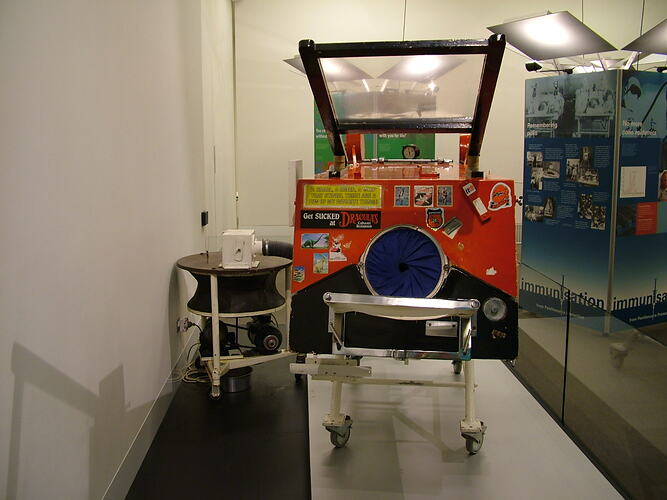 Painted iron lung in museum display.