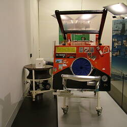 Painted iron lung in museum display.