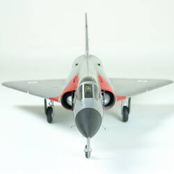 Front view of plastic silver model aeroplane. Red stripes and red, white and blue bulleyes on wings.