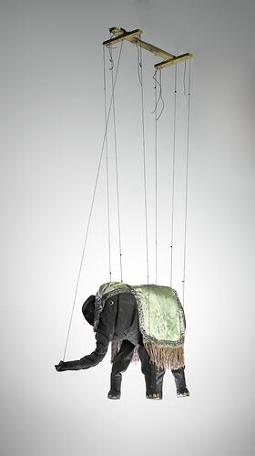 Grey elephant marionette with grey silk coat. Wooden handle, strings attached.