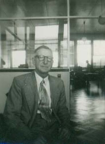 Portrait of a man sitting in an office.