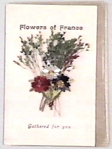 Card on white paper with floral arrangement in centre and text above and below.