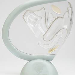 Model with clear plastic encasing scaled-down female reproductive organs, mounted on a stand.