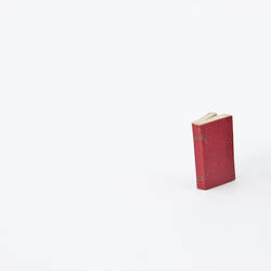 Red covered book with white pages.