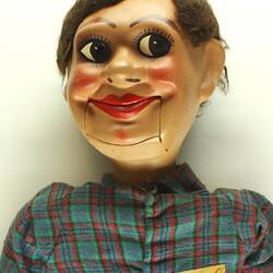 Ventriloquist doll with a green plaid shirt.
