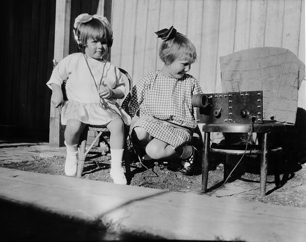 Two girls listening to home made radio.