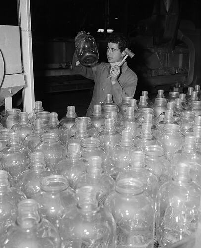Negative - Australian Consolidated Industries Ltd, Man holding Jar in Glass Factory, Spotswood, Victoria, 1958