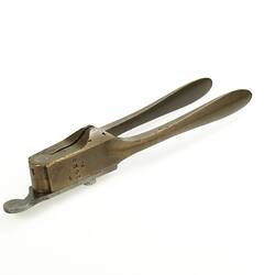 Hand-held brass bullet mould.