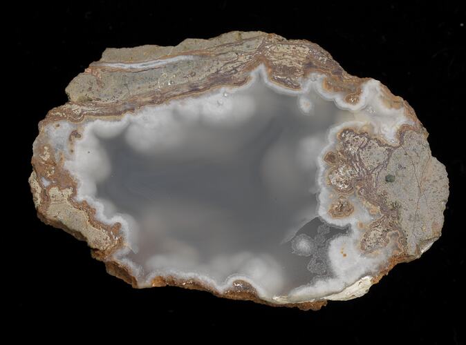 Cross section of cloudy grey and white agate.