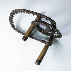 Metal folding saw, two wood handles.