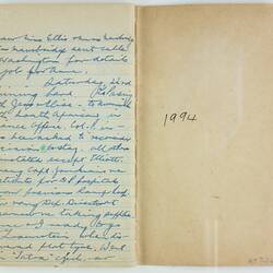 Open book, one cream page, cursive handwritten text, blue ink. Page 118. Card cover on right.