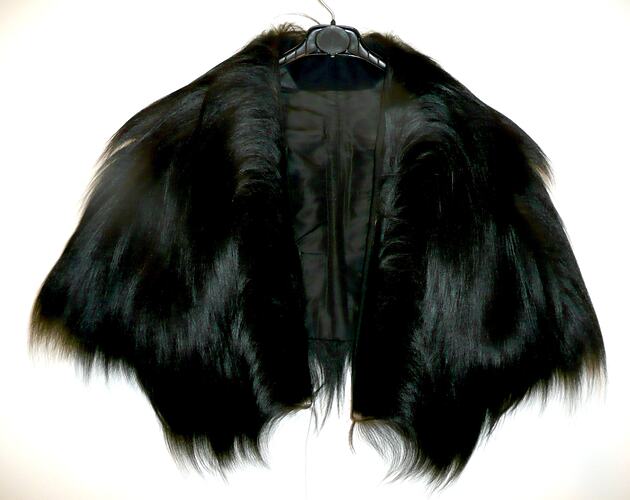 Black fur cape, lying flat.