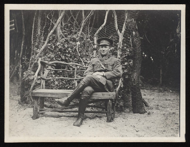 Monochrome photograph of a serviceman sitting.