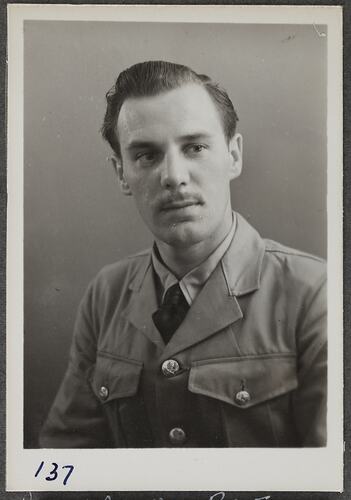 Studio portrait of man in military uniform.