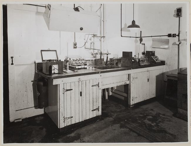 Bench, with sink, holding laboratory equipment.